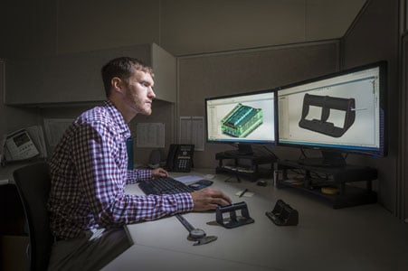 Rodon Employee observes mold design on computer
