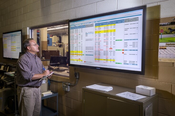 Rodon employee checks monitor in facility for project status