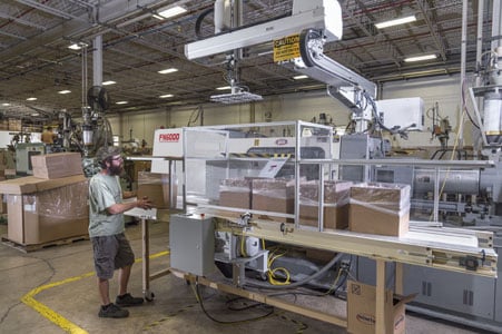 Rodon employee operating machinery in the facility