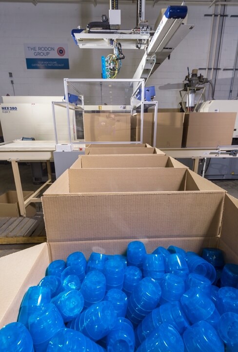 box filled with blue plastic injection molded components